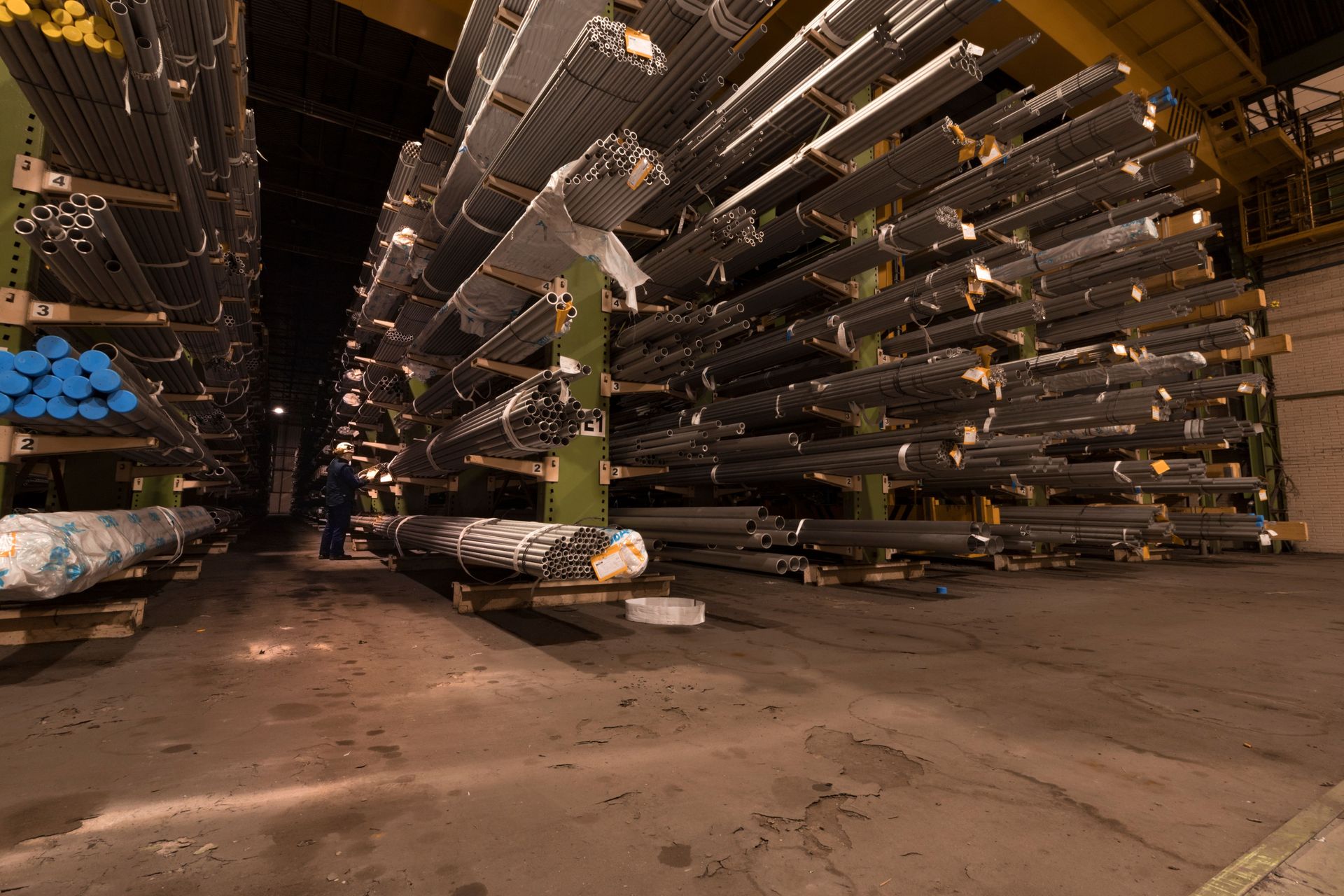 Warehouse aisle with racked alloy steel stock